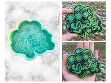 Load image into Gallery viewer, Plaid Lucky Shamrock Freshie Mold, smiling lucky clover freshie mold, St Patrick&#39;s day freshie mold, Irish freshie mold, silicone soap molds
